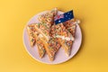 The famous traditional Australian food Fairy Bread on a yellow background