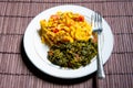 Famous traditional Jamaican ackee & saltfish breakfast, steamed callaloo seasoned with tomatoes, thyme, onions, escallion