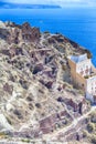 Famous Travel Places. Stunning View of Part of Oia Village in Santorini Island in Greece. Located Over Caldera Mountains with Boat Royalty Free Stock Photo