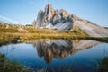 Famous Tre Cime di Lavaredo reflected in small pond, Dolomites Alps Mountains, Italy, Europe. Tre Cime mount in Royalty Free Stock Photo