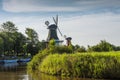 The historic two windmills along the canal in the village Greetsiel, Eastern Frisia, Germany