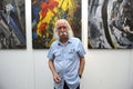 Famous Ukrainian painter Ivan Marchuk standing in front of his works during opening his personal exhibition of paintings