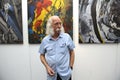 Famous Ukrainian painter Ivan Marchuk standing in front of his works during opening his personal exhibition of paintings