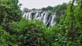 The famous Victoria Falls. Water flowing along the stony bed of the Zambezi River falls into the abyss Royalty Free Stock Photo