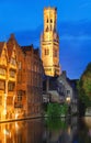 Famous view of Bruges tourist landmark attraction - Rozenhoedkaai canal with Belfry and old houses along canal with tree Royalty Free Stock Photo