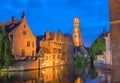 Famous view of Bruges tourist landmark attraction - Rozenhoedkaai canal with Belfry and old houses along canal with tree Royalty Free Stock Photo