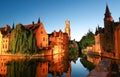 Famous view of Bruges tourist landmark attraction - Rozenhoedkaai canal with Belfry and old houses along canal with tree Royalty Free Stock Photo