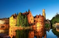 Famous view of Bruges tourist landmark attraction - Rozenhoedkaai canal with Belfry and old houses along canal with tree Royalty Free Stock Photo