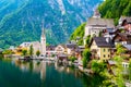 Famous view of Hallstatt city and church near the lake. Mountains in the background. Summer rainy day, soft colors, cloudy weather Royalty Free Stock Photo