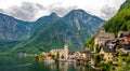 Famous view of Hallstatt city and church near the lake. Mountains in the background. Summer rainy day, soft colors, cloudy weather Royalty Free Stock Photo