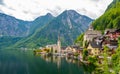 Famous view of Hallstatt city and church near the lake. Mountains in the background. Summer rainy day, soft colors, cloudy weather Royalty Free Stock Photo