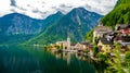 Famous view of Hallstatt city and church near the lake. Mountains in the background. Summer rainy day, soft colors, cloudy weather Royalty Free Stock Photo