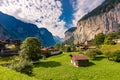 Famous view of Lauterbrunnen town in Swiss Alps valley with gorgeous Staubbach waterfalls in the background, Switzerland Royalty Free Stock Photo