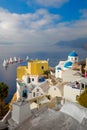 The famous view of the sights of Santorini - white houses, blue domes and yachts in the azure sea. Santorini island, Greece, Royalty Free Stock Photo