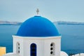 Famous view from viewpoint of Santorini Oia village with blue dome of greek orthodox Christian church Royalty Free Stock Photo