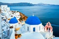 Famous view from viewpoint of Santorini Oia village with blue dome of greek orthodox Christian church Royalty Free Stock Photo