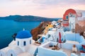 Famous view from viewpoint of Santorini Oia village with blue dome of greek orthodox Christian church Royalty Free Stock Photo