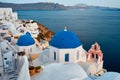 Famous view from viewpoint of Santorini Oia village with blue dome of greek orthodox Christian church Royalty Free Stock Photo