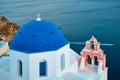 Famous view from viewpoint of Santorini Oia village with blue dome of greek orthodox Christian church Royalty Free Stock Photo