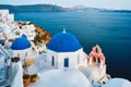Famous view from viewpoint of Santorini Oia village with blue dome of greek orthodox Christian church Royalty Free Stock Photo