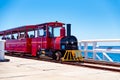 Famous vintage Jetty Train with passengers driving down the jetty