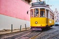 Famous vintage yellow tram 28 in the narrow streets of Alfama district in Lisbon, Portugal