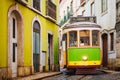 Famous vintage yellow tram 28 in the narrow streets of Alfama district in Lisbon, Portugal Royalty Free Stock Photo