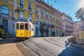 Famous vintage yellow tram 28 in the narrow streets of Alfama district in Lisbon, Portugal Royalty Free Stock Photo