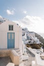 Famous white buildings on street in Santorini, Greece