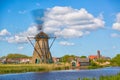 Famous windmills in Kinderdijk village in Holland. Spinning windwill. Colorful spring landscape in Netherlands, Europe. UNESCO Wor