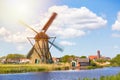 Famous windmills in Kinderdijk village in Holland. Spinning windwill. Colorful spring landscape in Netherlands, Europe. UNESCO