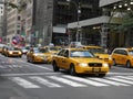 The famous yellow taxis rushing in NYC in a beautiful day