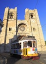 Famous yellow tram running in front of Se Cathedral in Lisbon