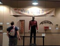 Fan admiring many items in Jean-Luc Picard exhibit at Star Trek Convention