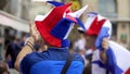 Fan of French soccer clapping hands, proud of favorite team, winning game