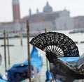 fan in the hand of the woman in Venice in Italy