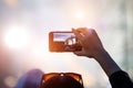 Fan at outdoor music festival taking pictures and making videos using his smartphone Royalty Free Stock Photo