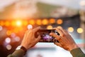 Fan at outdoor music festival taking pictures and making videos using his smartphone Royalty Free Stock Photo