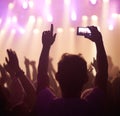 Fan, phone filming and band on stage with excited audience, lighting colors and music performance on video. Smartphone Royalty Free Stock Photo