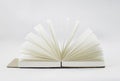 Fan unfold open small notepad with blank light beige pages. Notebook, sketchbook. White backdrop Royalty Free Stock Photo