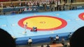 Fan is watching duelling on combat sambo. View od action is defocused and then becomes focused. Focuse changing.