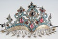 Fancy, antique tiara with precious, colorful stones isolated on a white background, close-up