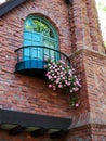 Fancy brick house detail with balcony and geranium