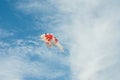 Fancy carp fish shaped kite flying in blue cloudy sky Royalty Free Stock Photo