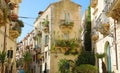 Fancy cozy decorated narrow street in Ortygia old town of Syracuse in Sicily, Italy