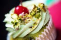 Fancy cupcake with pistachio and cherry
