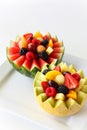 Fancy cut melon and watermelon with assorted fruit inside on a white background Royalty Free Stock Photo