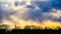 Fancy dark rain clouds over landscape at sunset Royalty Free Stock Photo