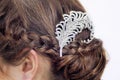 Fancy diamond brooch in brunette's hair.