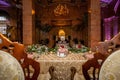 Fancy dining table with table golden wear and superb chairs with brown walls and ceiling lamps Royalty Free Stock Photo